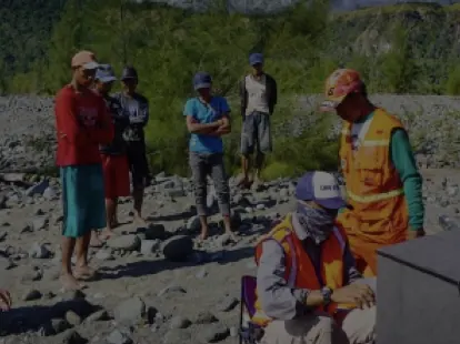 Survey team with equipment on the Bongka riverbank